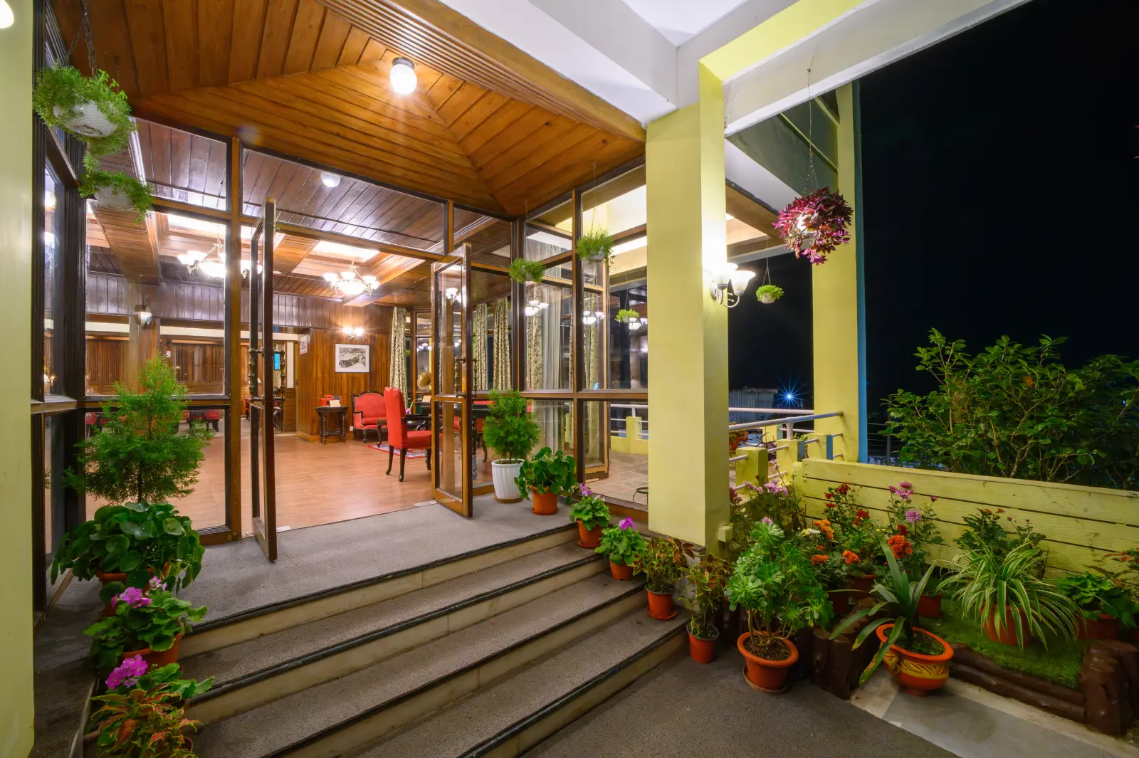 The warmly lit entrance porch at Sinclairs Darjeeling