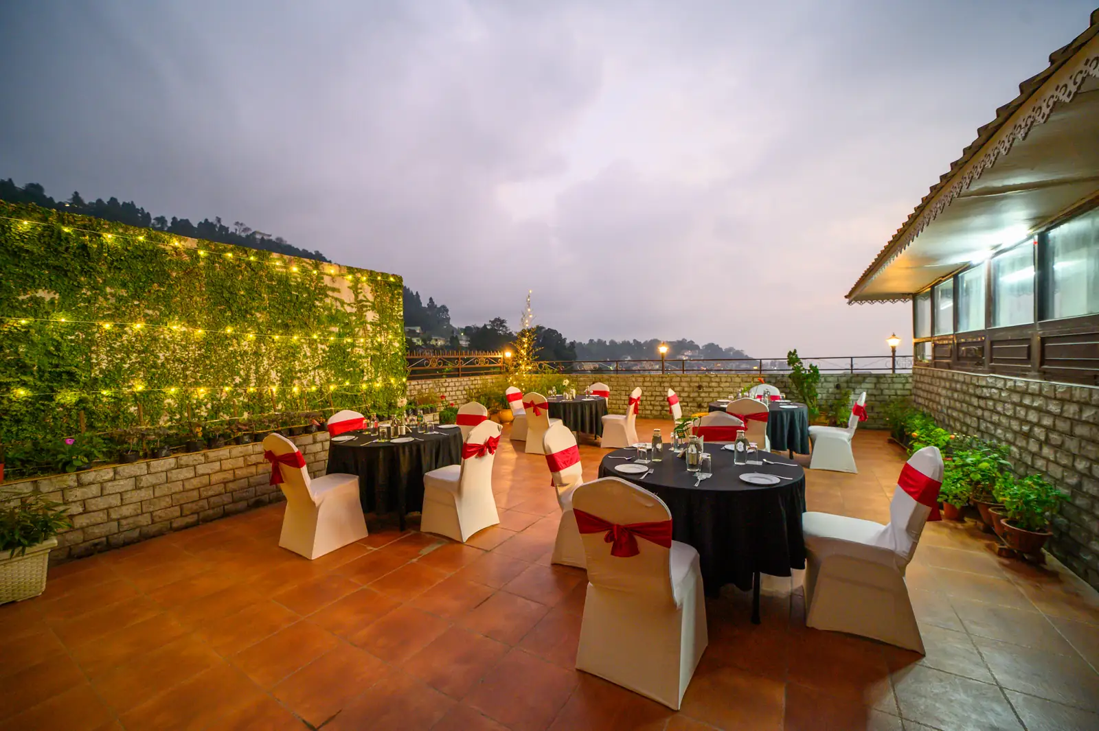 Candlelit rooftop terrace dining set-up in the evening at Sinclairs Gangtok