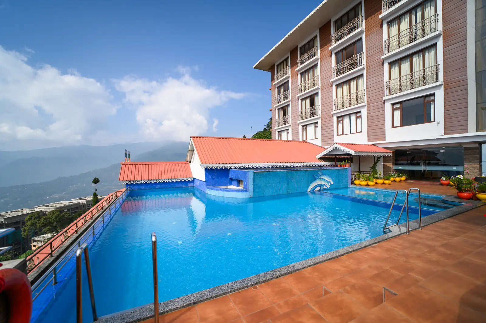 Infinity-edge swimming pool at Sinclairs Gangtok overlooking the Himalayan foothills