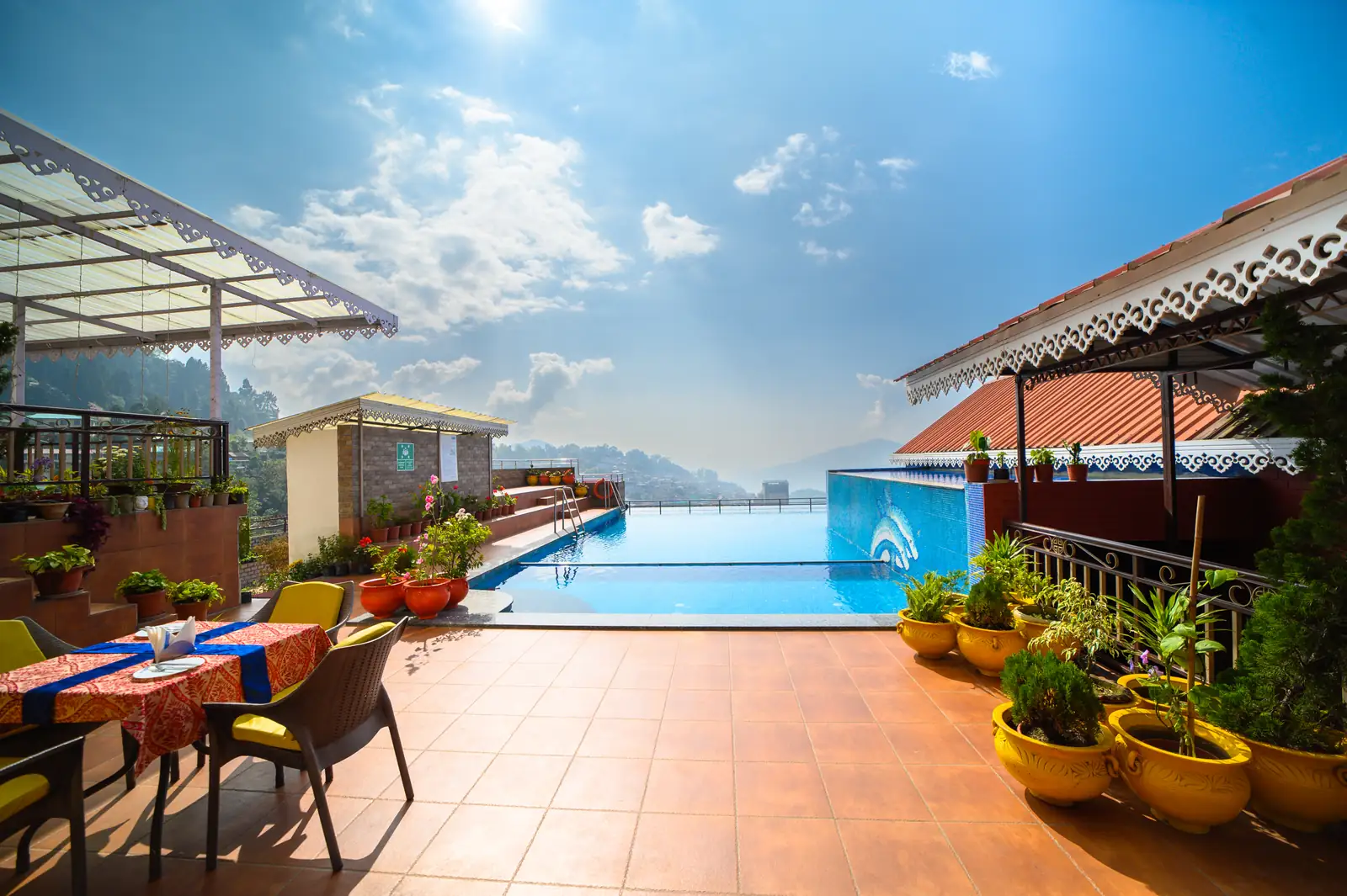 Poolside deck chairs and mountain views at Sinclairs Gangtok